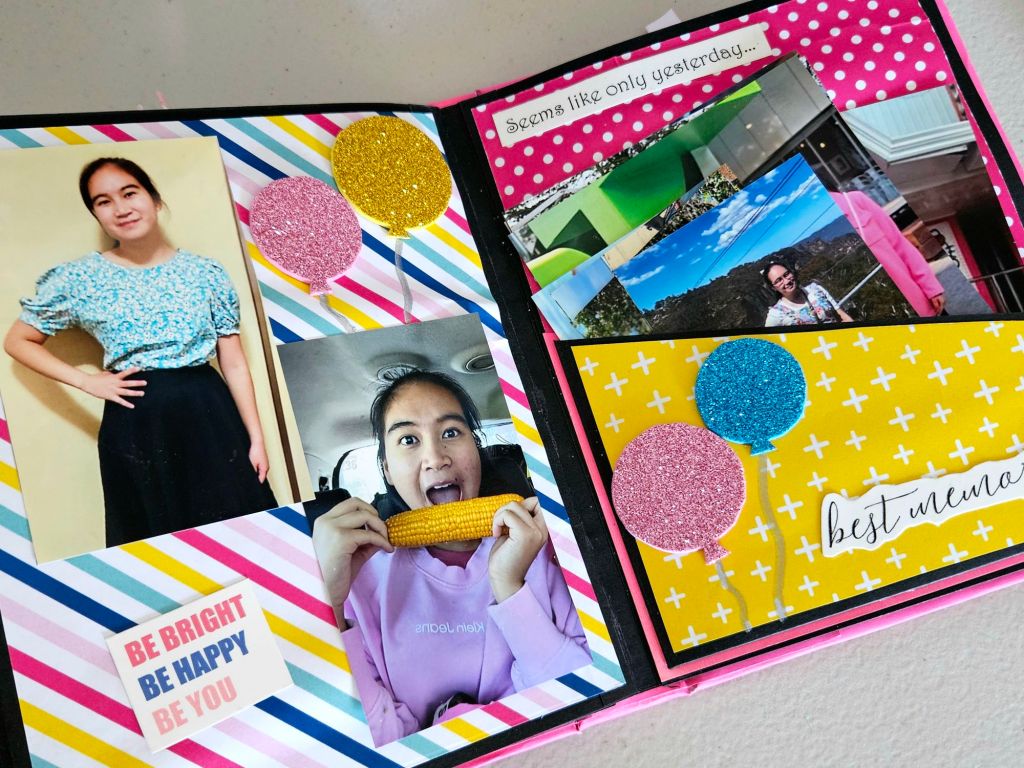 Bright and playful birthday scrapbook with pink, blue, and yellow elements, capturing joyful moments