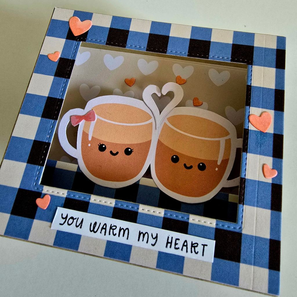 Inside view of a coffee-themed shadow box card, displaying layered digital prints and charming coffee cup couple artwork.