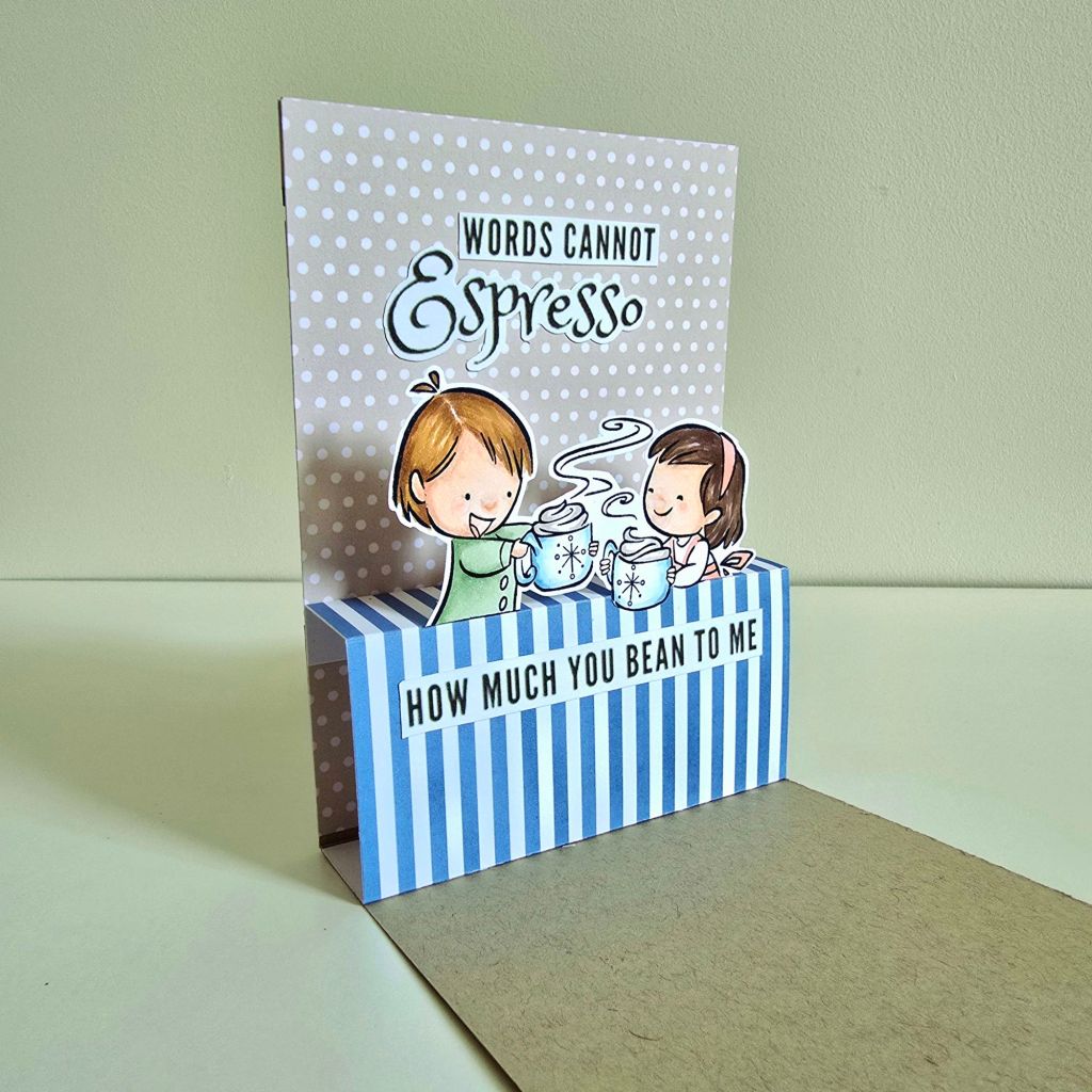 Coffee-inspired handmade card with a café storefront cover and a delightful surprise inside—a beautifully designed pop-up couple enjoying a coffee date.